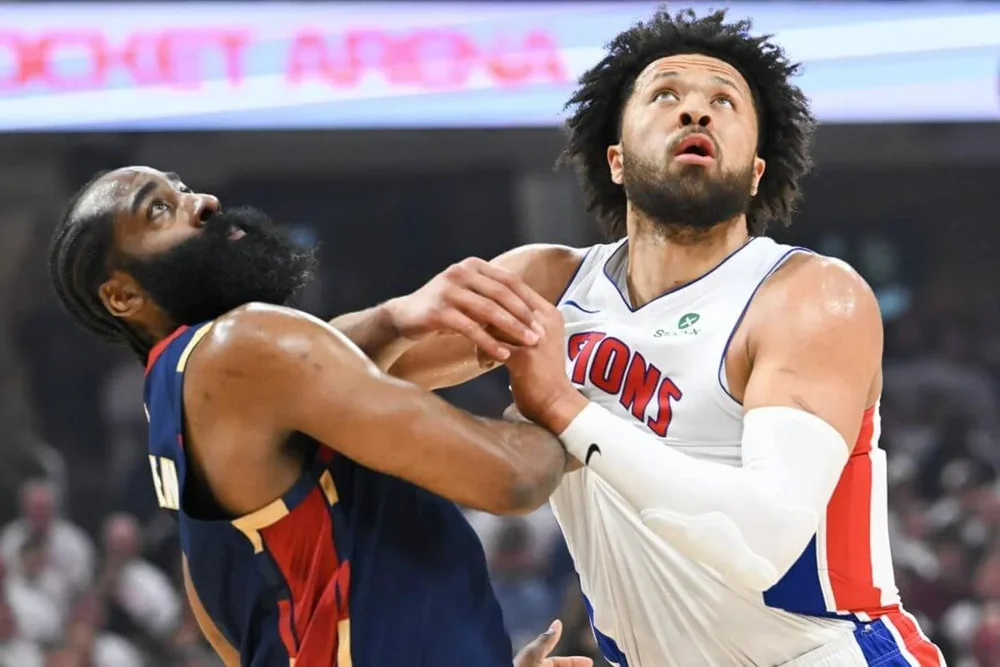 James Harden and Cade Cunningham jostle for a rebound.